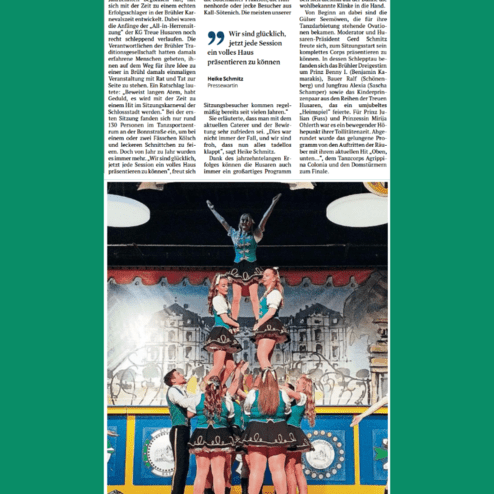 Tanzgruppe der Treuen Husaren zeigt eine Formation mit mehreren Tänzerinnen auf der Bühne während einer Veranstaltung.