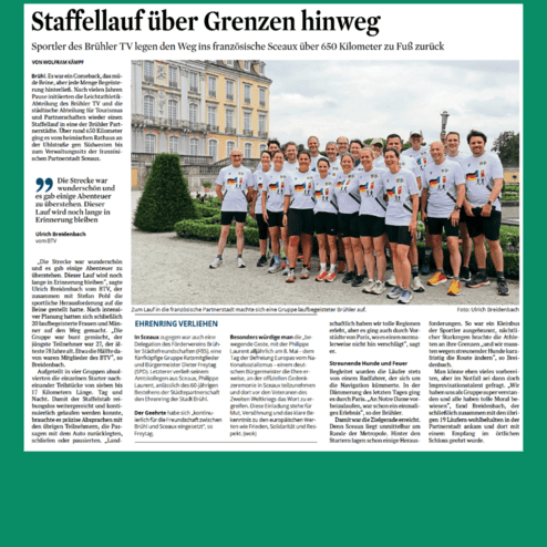 Gruppe von 20 Läufern des Brühler TV posiert vor einem historischen Gebäude in Sévran, Frankreich, nach einem Staffellauf.