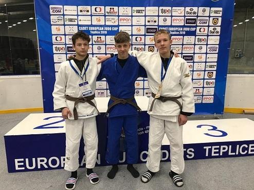 Drei Judoka stehen auf dem Podest bei der European Judo Cup Veranstaltung in Teplice, einer in blauer und zwei in weißen Judogis.